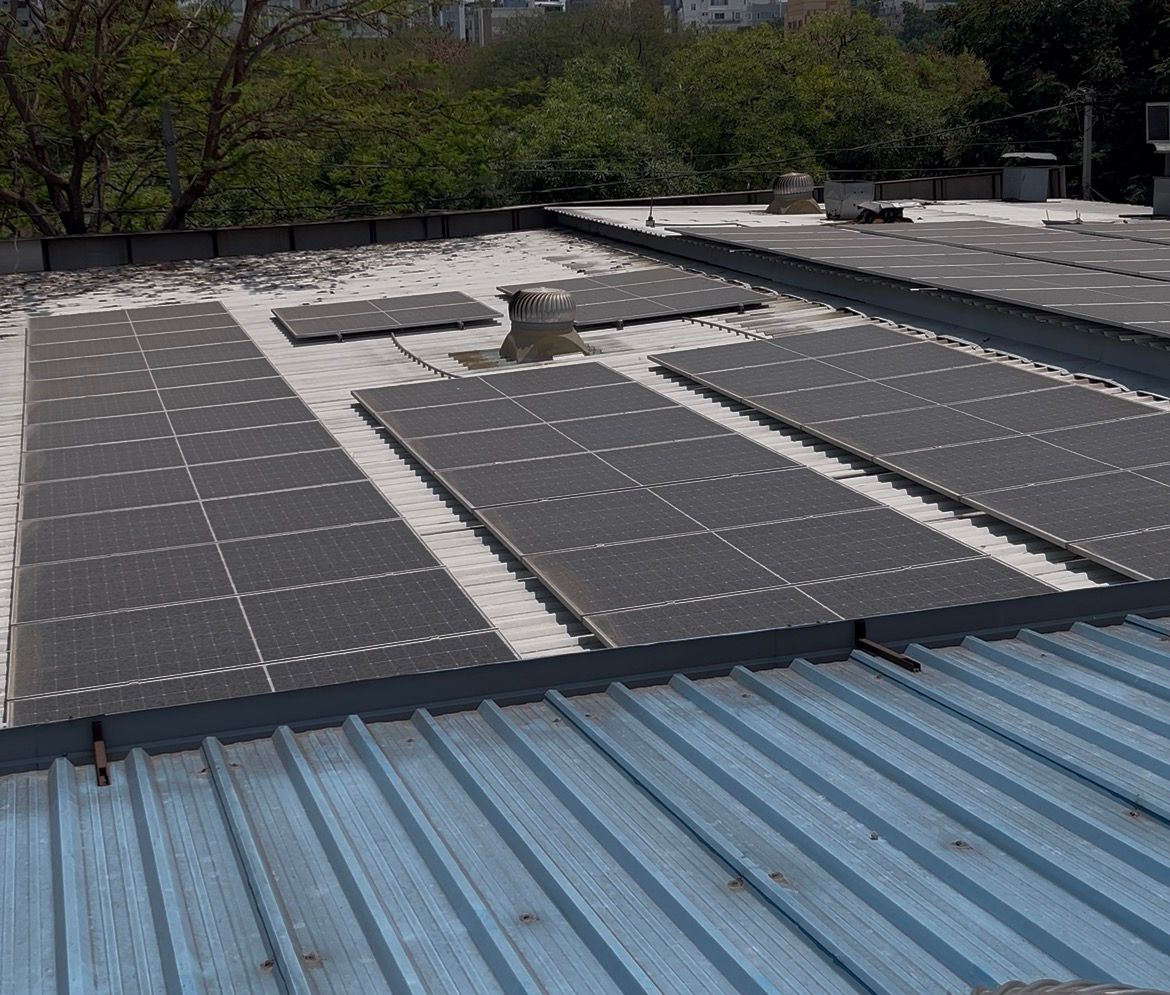 Aerial view of large-scale industrial rooftop solar panel installation in Hyderabad